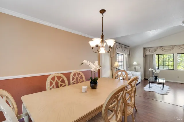 a view of a dining room with furniture wooden floor and chandelier