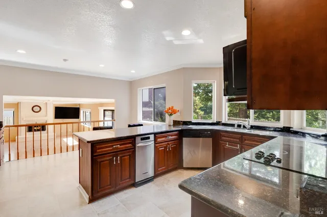 a kitchen with stainless steel appliances granite countertop a sink stove and oven