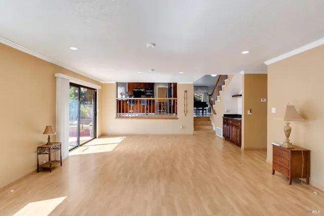 a big room with wooden floor and windows