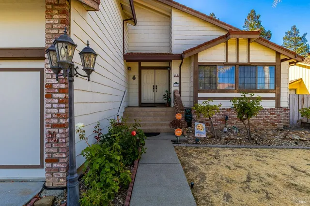 a view of a house with potted plants