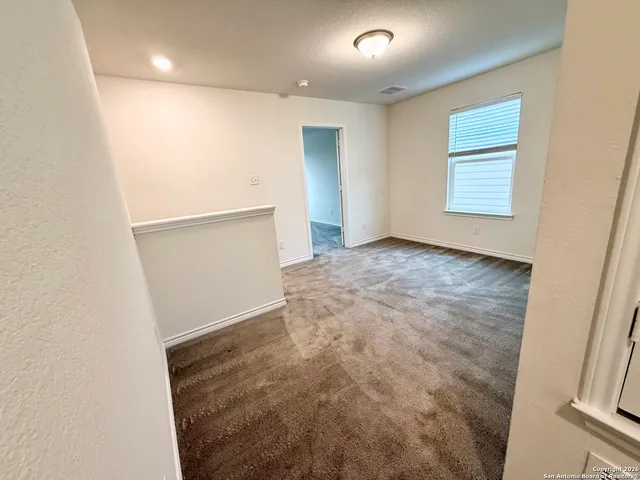 a room with a bed and a large window