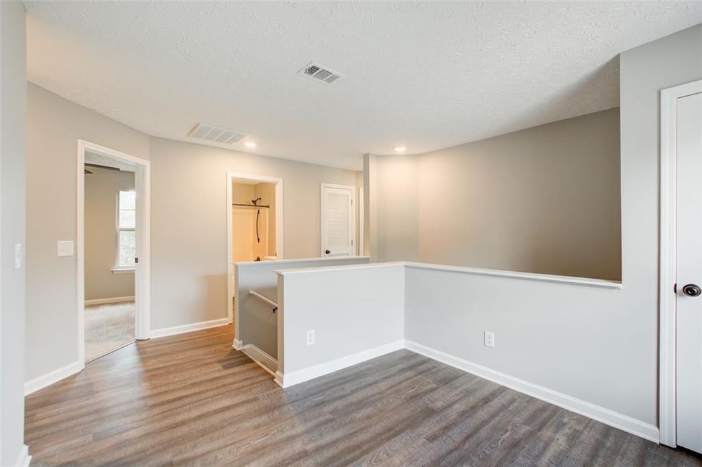 4110 Ridgebrook Bend Cumming, GA 30028 - Photo 24 of 49 a view of an empty room with wooden floor and a window