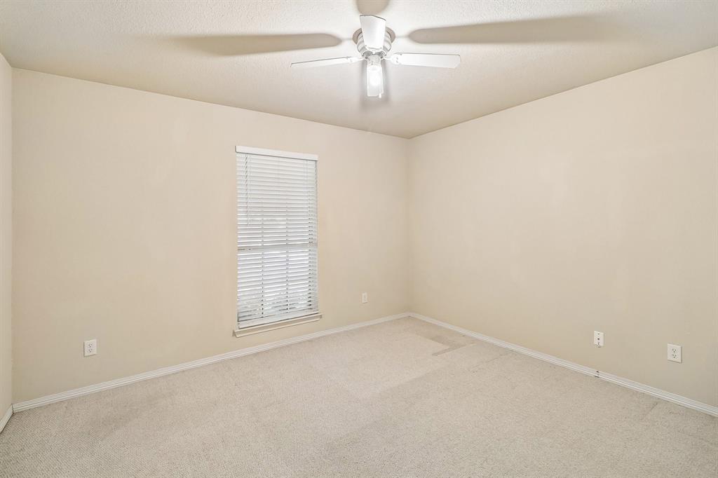 5609 Saddleback Road Arlington, TX 76017 - Photo 11 of 23 an empty room with windows and fan