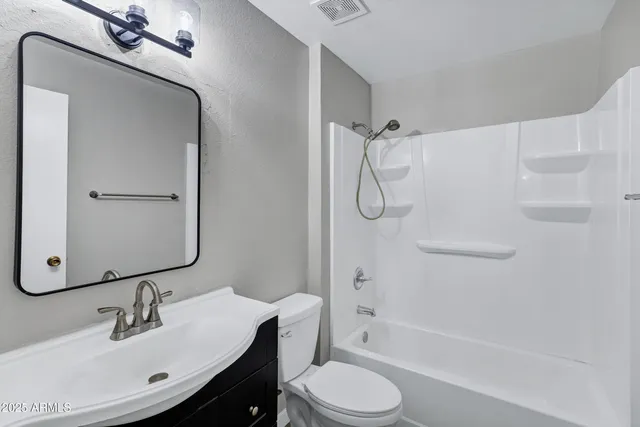 a bathroom with a toilet sink and shower