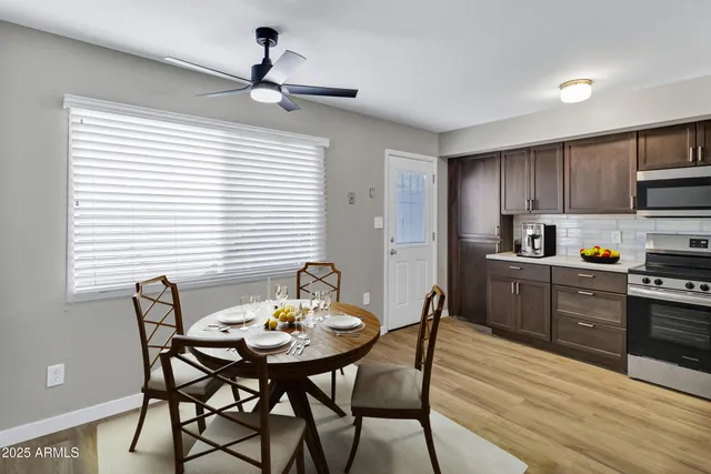 a kitchen with a table chairs and cabinets