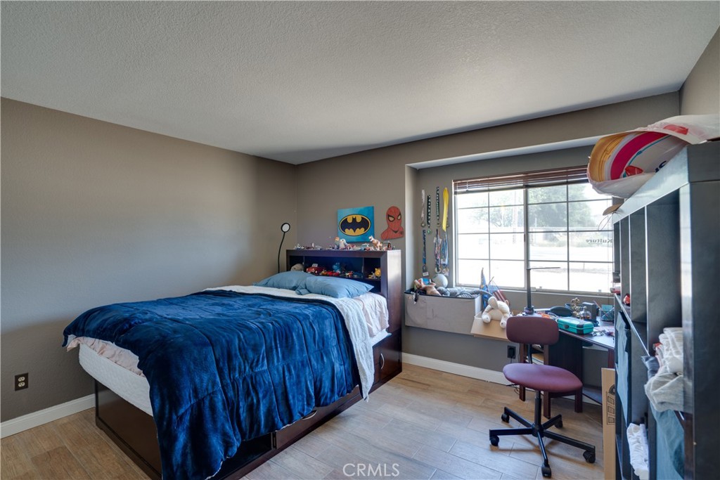 18825 Mariposa Avenue Riverside, CA 92508 - Photo 27 of 55 a bedroom with a bed and a chair