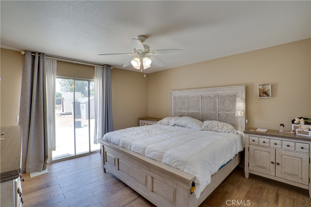 18825 Mariposa Avenue Riverside, CA 92508 - Photo 28 of 55 a spacious bedroom with a bed and a chandelier
