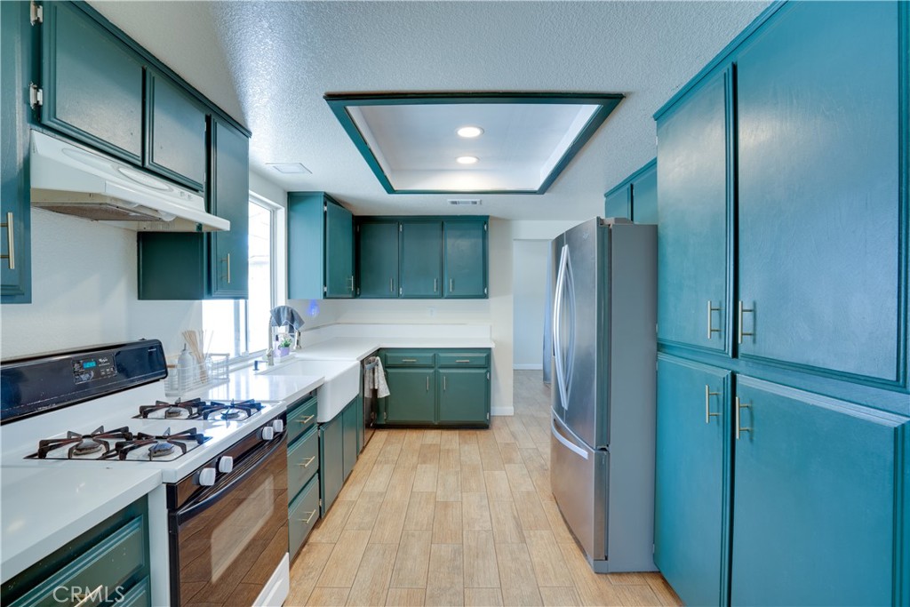 18825 Mariposa Avenue Riverside, CA 92508 - Photo 37 of 55 a kitchen with stainless steel appliances granite countertop a stove a refrigerator and a stove