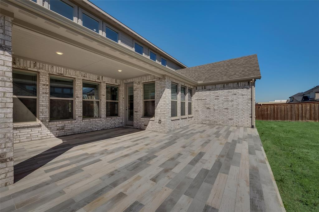 16476 Ryder Rock Road Frisco, TX 75033 - Photo 35 of 40 Covered back patio with custom tiled flooring and french drains