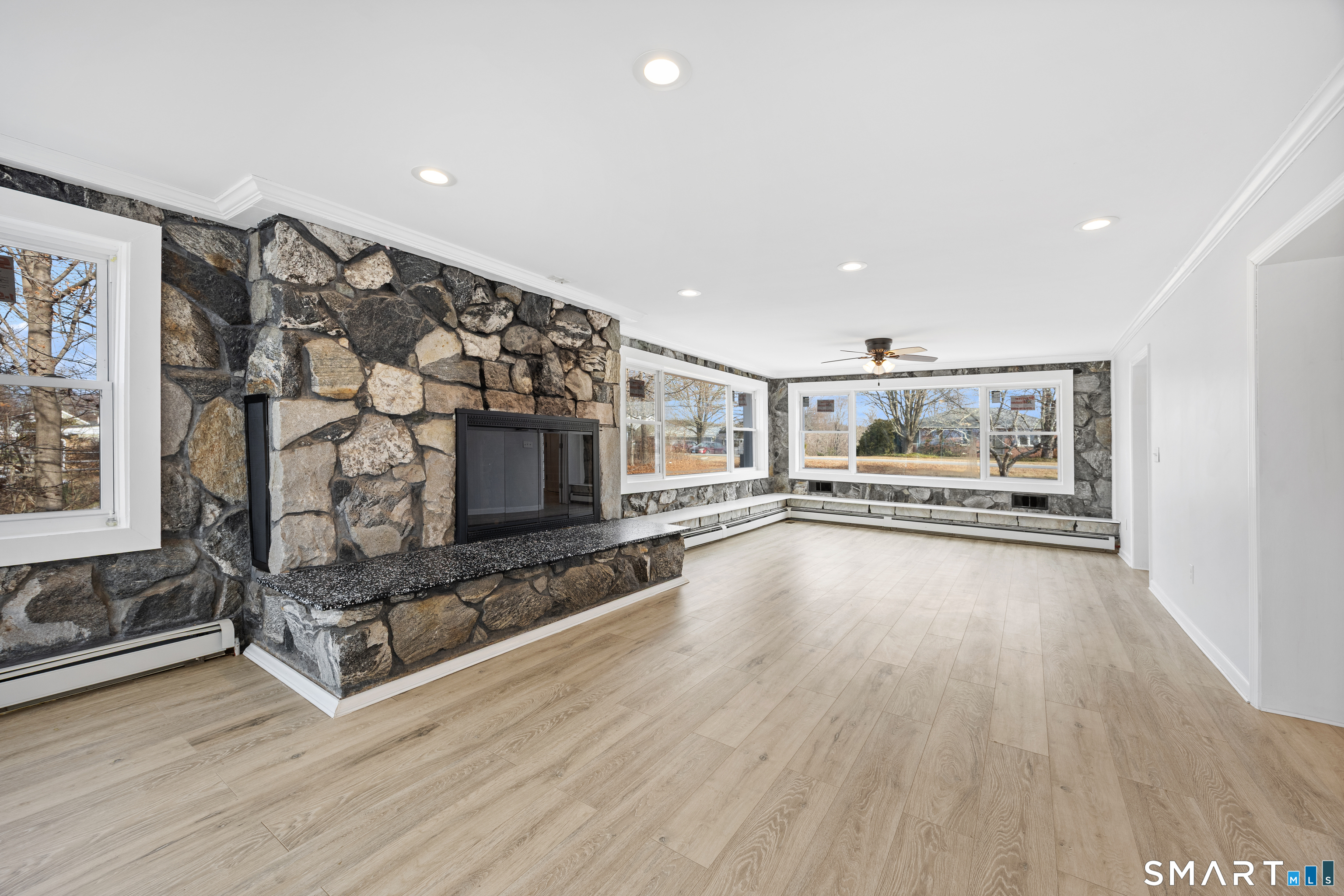 719 High Street Extension Thomaston, CT 06787 - Photo 11 of 38 a living room with hard wood floors and a fireplace