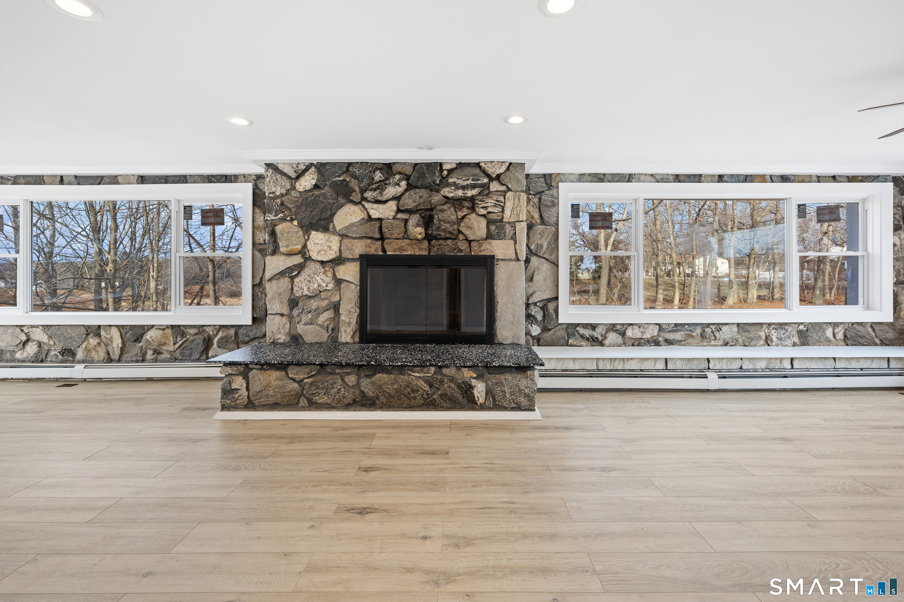 719 High Street Extension Thomaston, CT 06787 - Photo 12 of 38 a living room with a large window and a fireplace