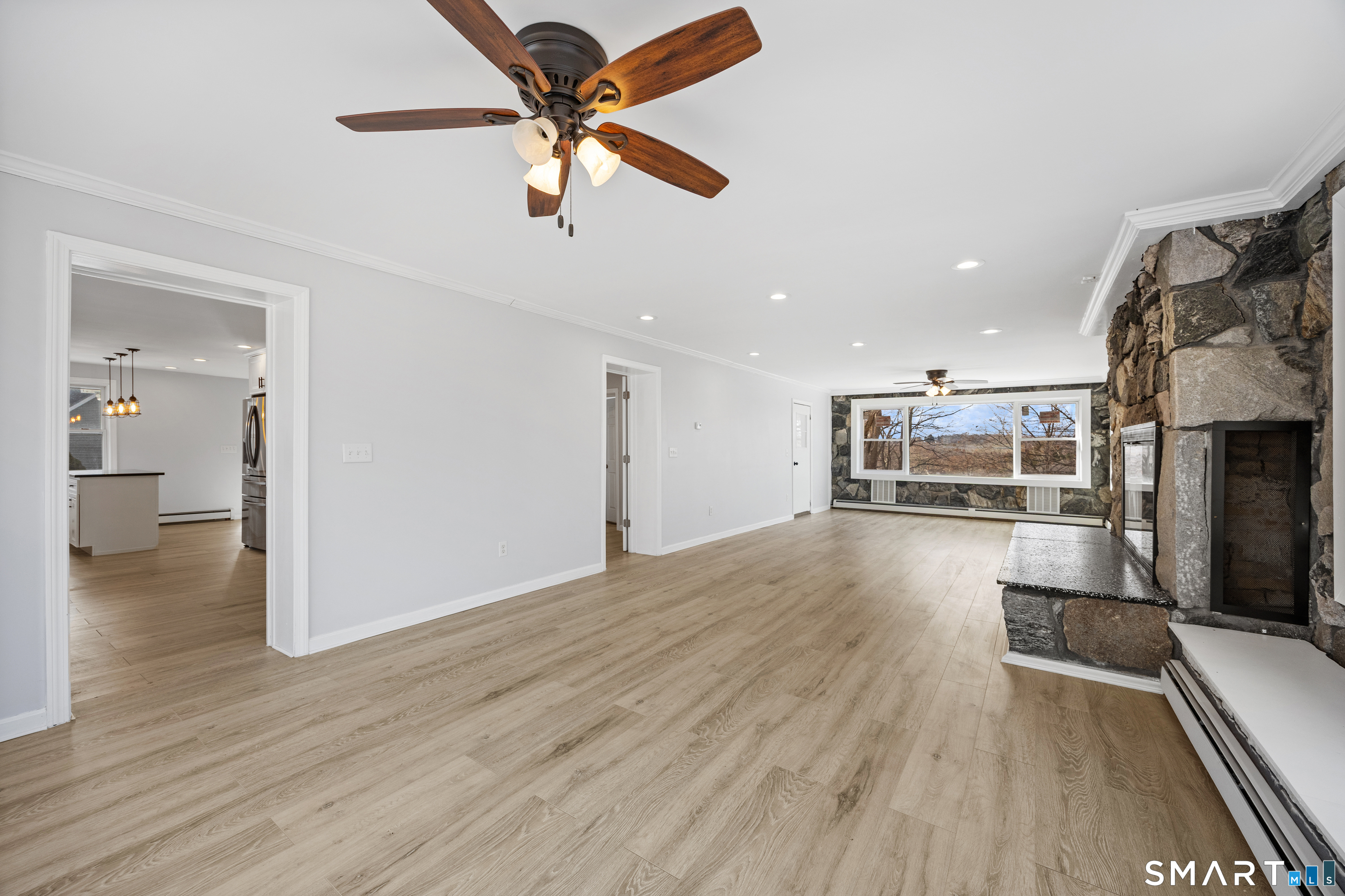 719 High Street Extension Thomaston, CT 06787 - Photo 13 of 38 a view of a livingroom with furniture a ceiling fan and wooden floor