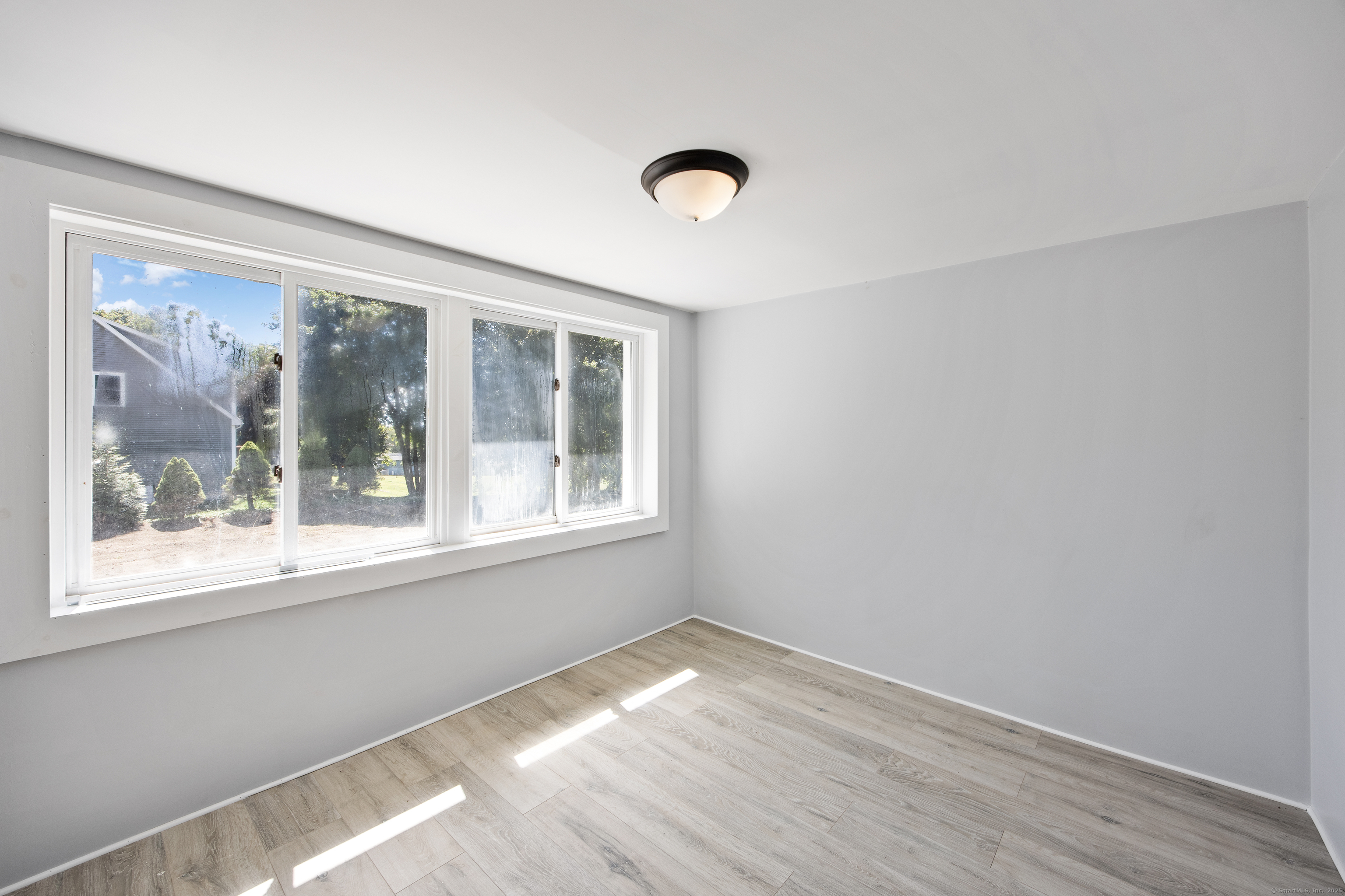 719 High Street Extension Thomaston, CT 06787 - Photo 16 of 38 a view of empty room with wooden floor and fan