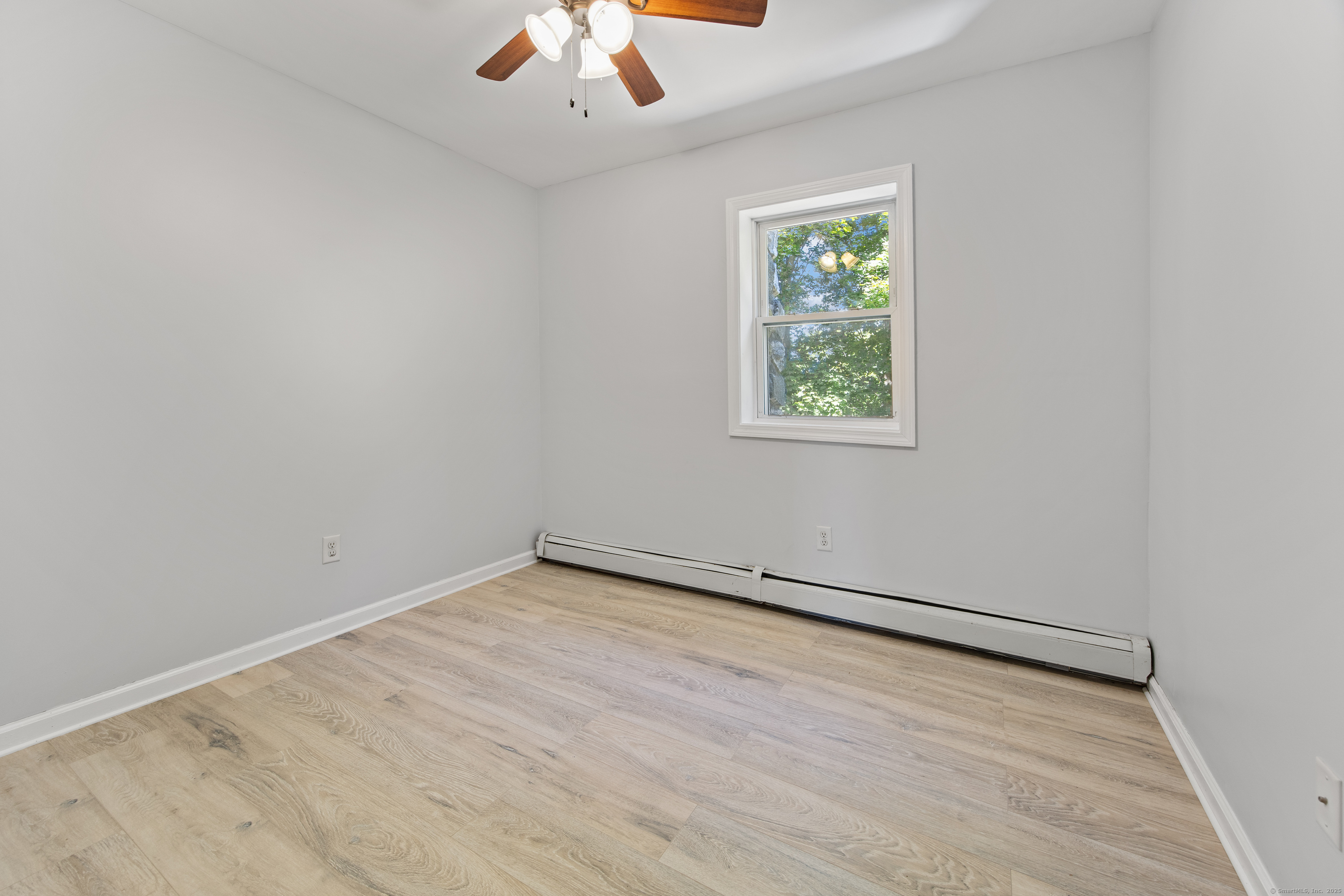 719 High Street Extension Thomaston, CT 06787 - Photo 27 of 38 an empty room with a window and a ceiling fan