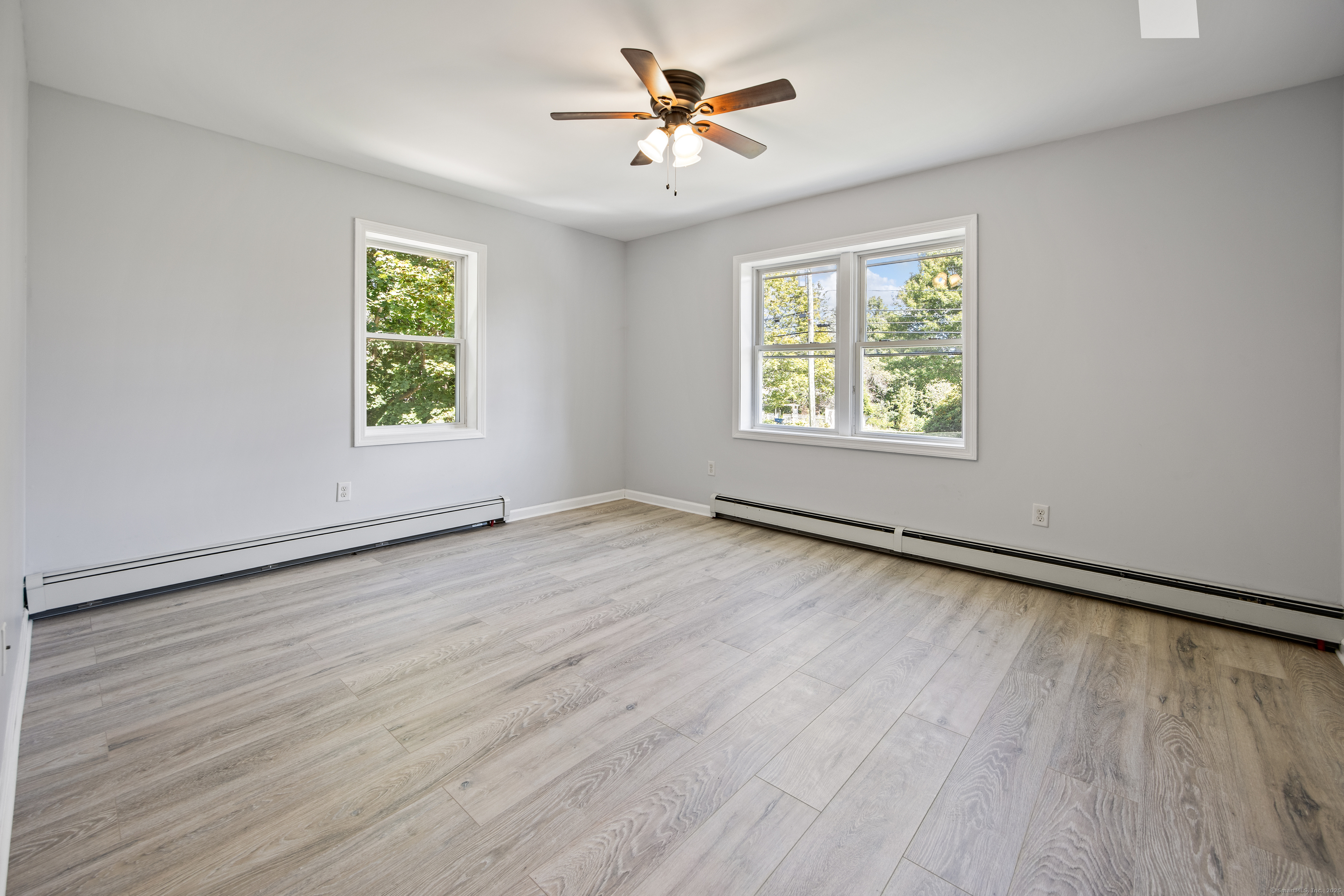 719 High Street Extension Thomaston, CT 06787 - Photo 29 of 38 an empty room with wooden floor and windows