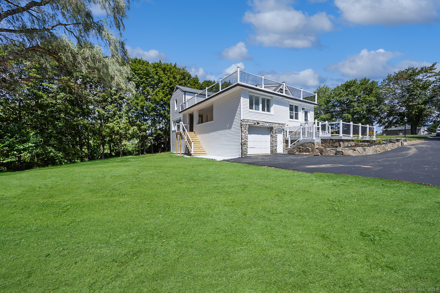 719 High Street Extension Thomaston, CT 06787 - Photo 37 of 38 a front view of a house with a garden and yard