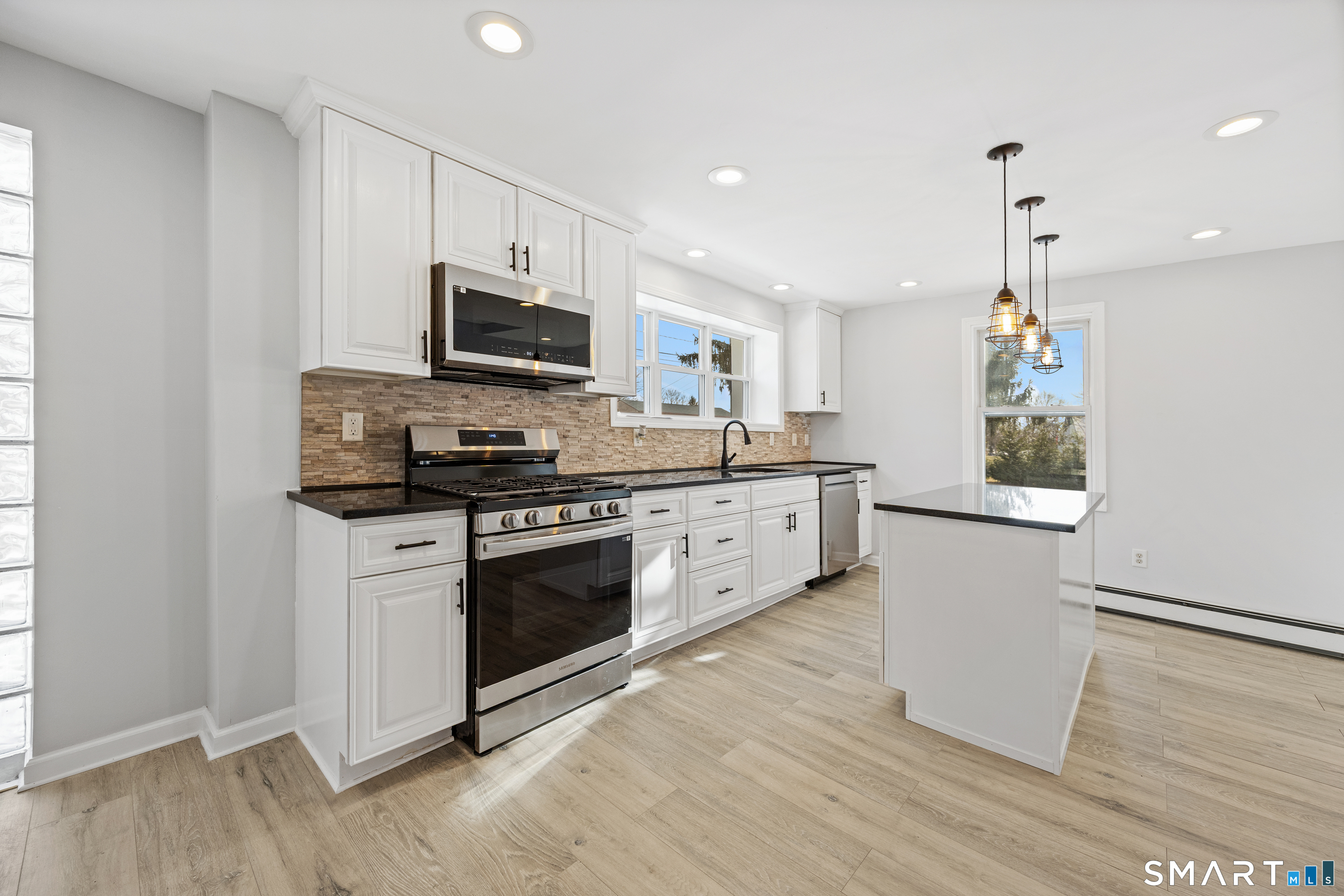 719 High Street Extension Thomaston, CT 06787 - Photo 6 of 38 a kitchen with stainless steel appliances granite countertop a stove top oven a sink and a microwave