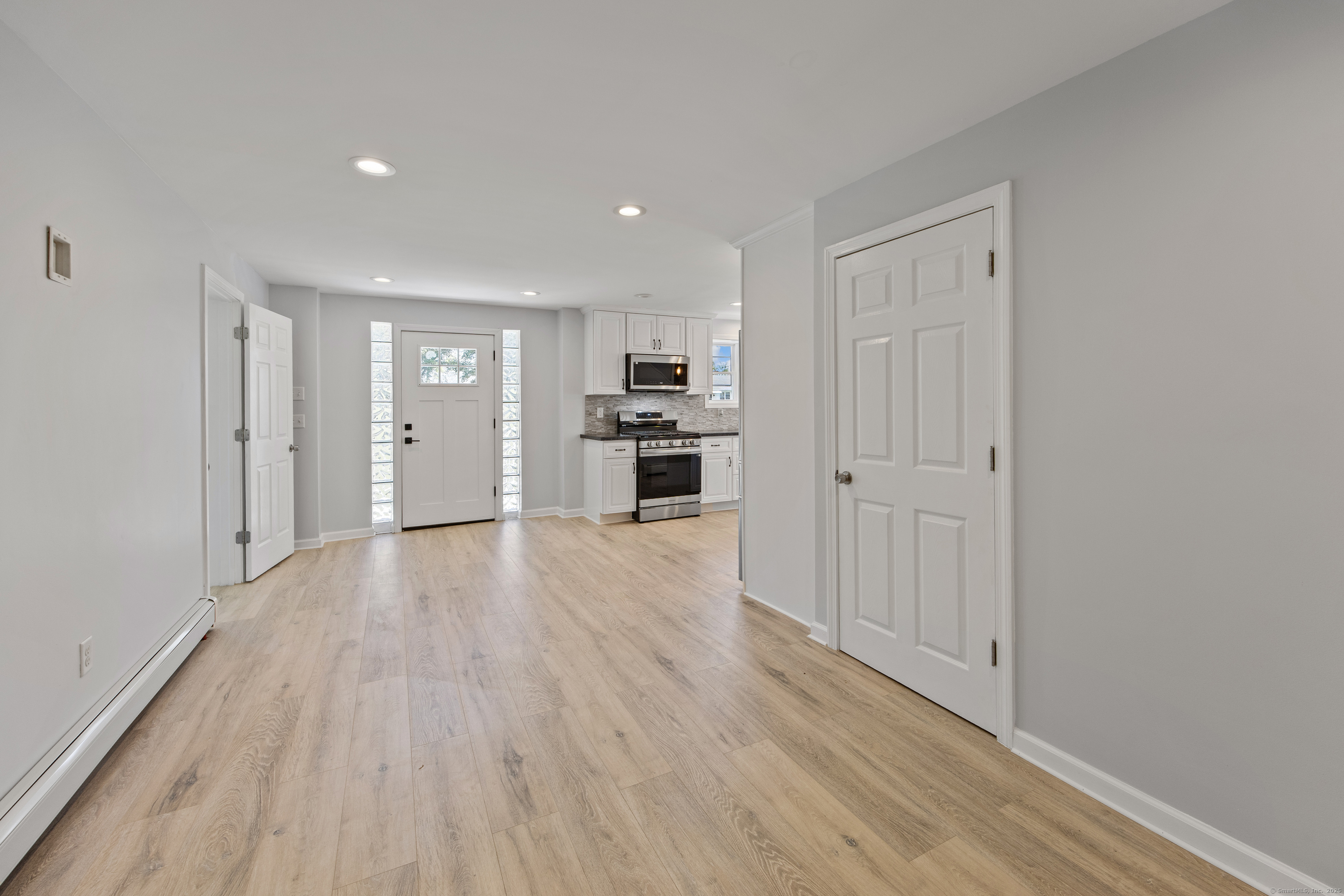 719 High Street Extension Thomaston, CT 06787 - Photo 10 of 38 a view of a kitchen with a sink and a refrigerator