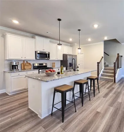 a large kitchen with granite countertop a stove and a sink