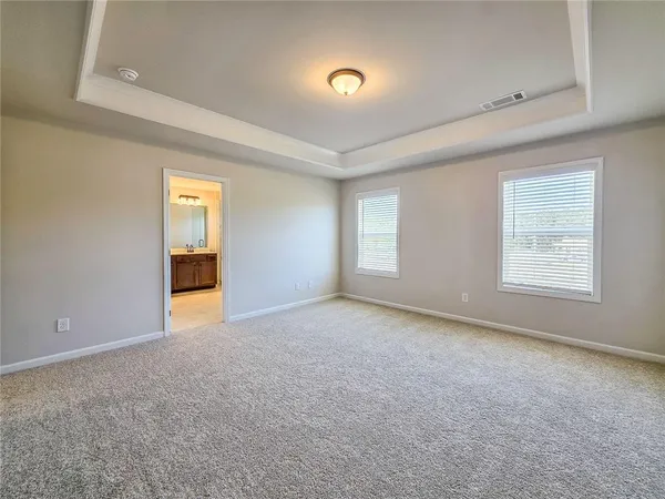 an empty room with a empty space and windows