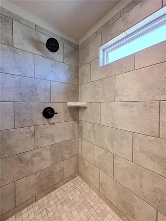 a bathroom with a sink a toilet a tub and shower