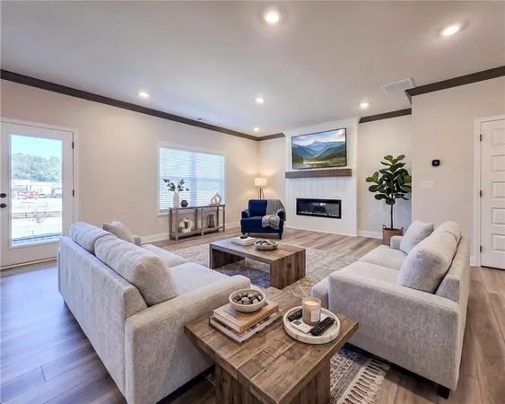 a view of empty room with wooden floor and fireplace