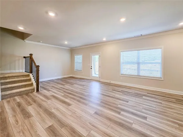 a view of a room with wooden floor and staircase