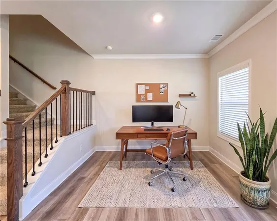 a view of empty room with wooden floor and fireplace