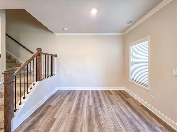 a view of a kitchen with cabinets and wooden floor