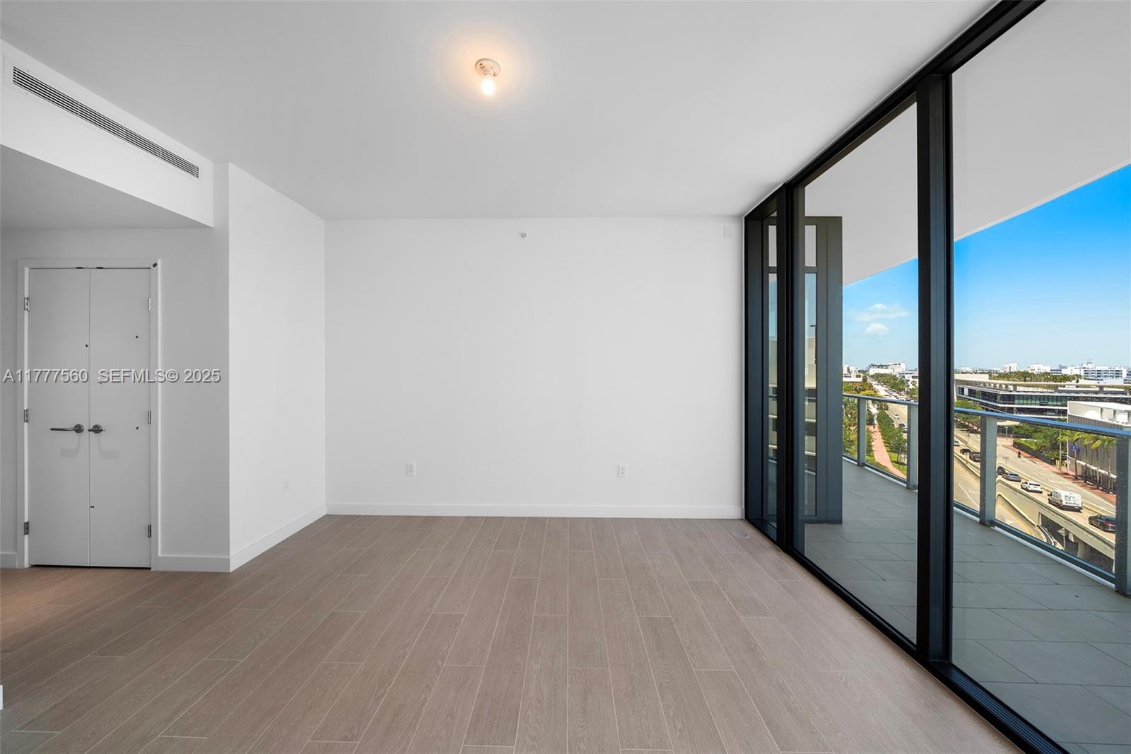500 Alton Road, Unit 801 Miami Beach, FL 33139 - Photo 14 of 36 a view of a hallway with wooden floor and door