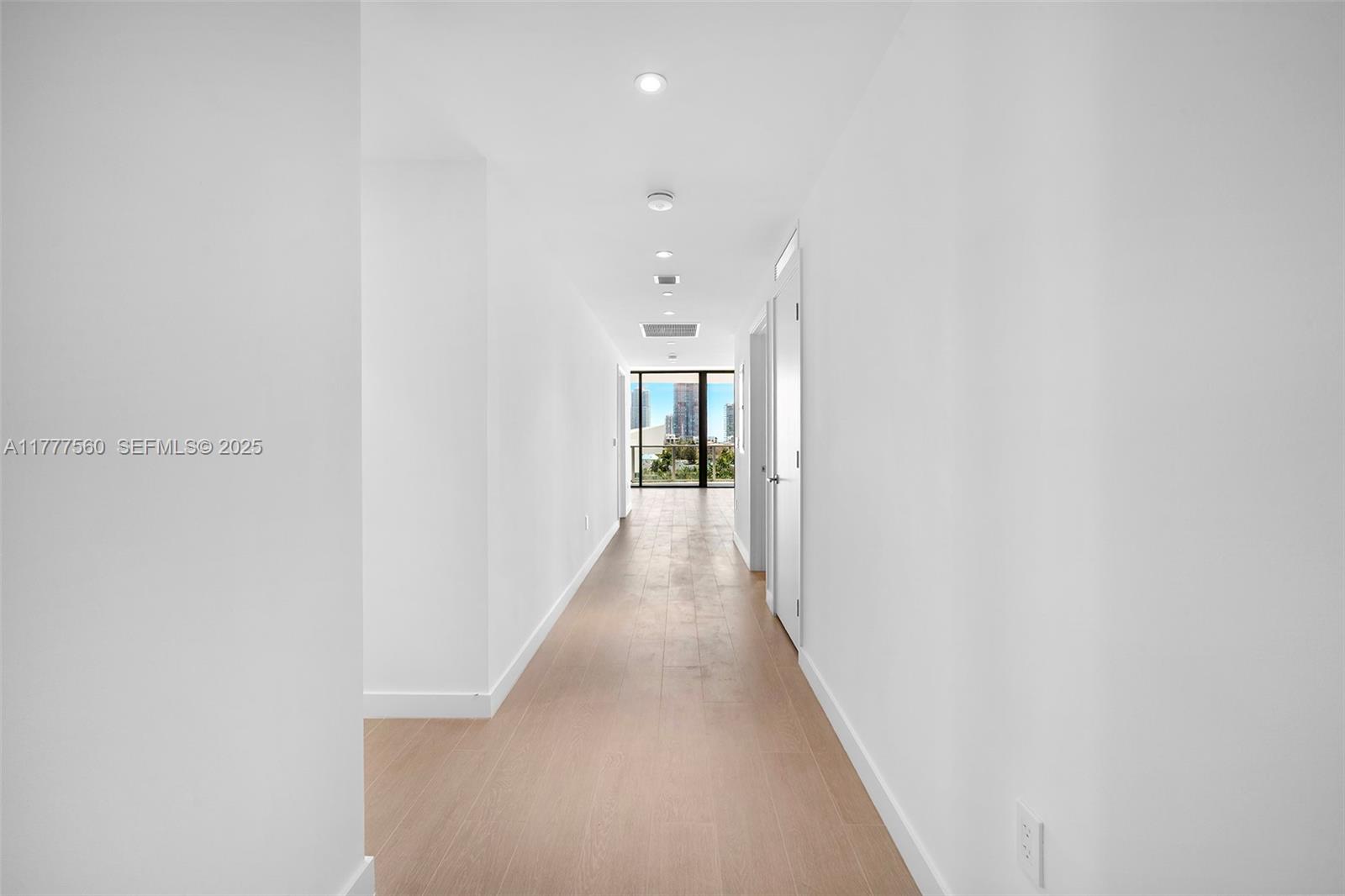 500 Alton Road, Unit 801 Miami Beach, FL 33139 - Photo 16 of 36 a view of a hallway with wooden floor