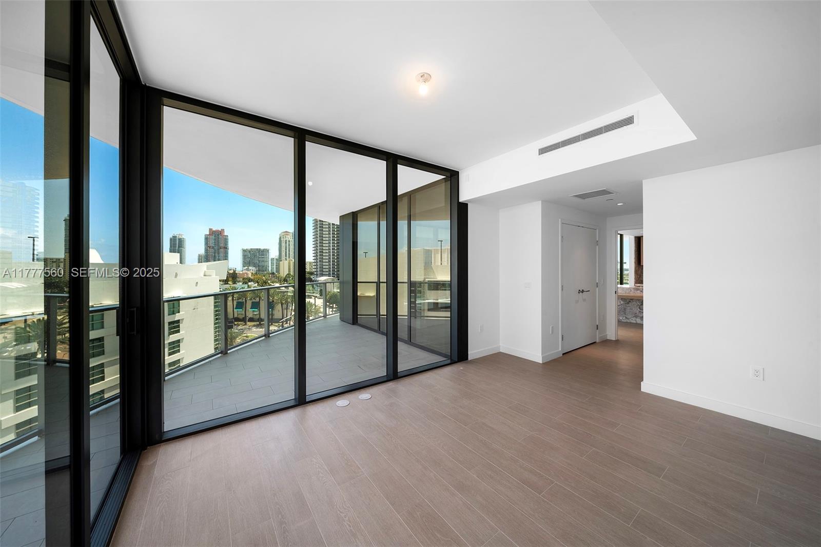500 Alton Road, Unit 801 Miami Beach, FL 33139 - Photo 30 of 36 a view of a hallway with wooden floor and a kitchen