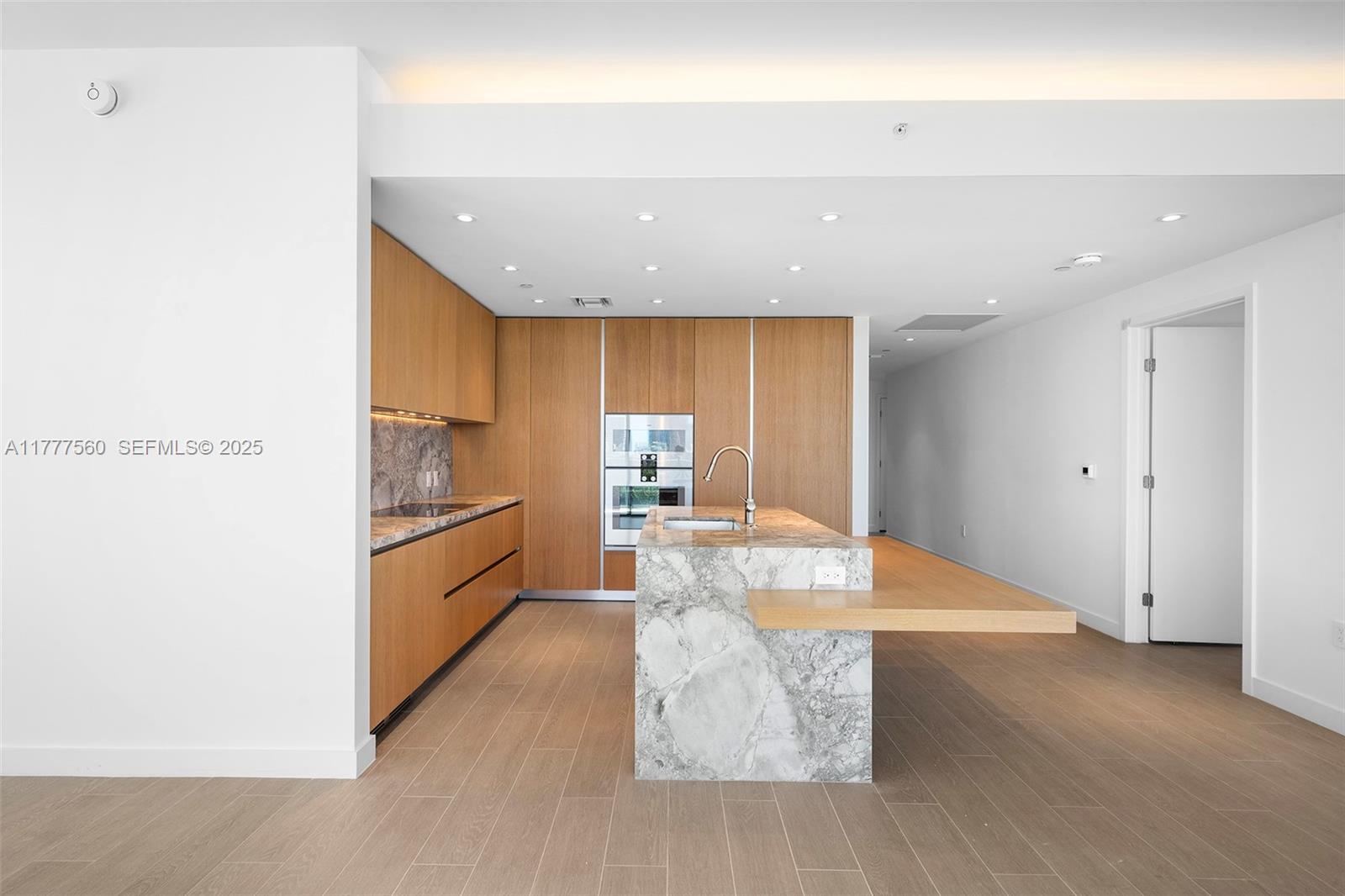 500 Alton Road, Unit 801 Miami Beach, FL 33139 - Photo 31 of 36 a large kitchen with a refrigerator and wooden floor