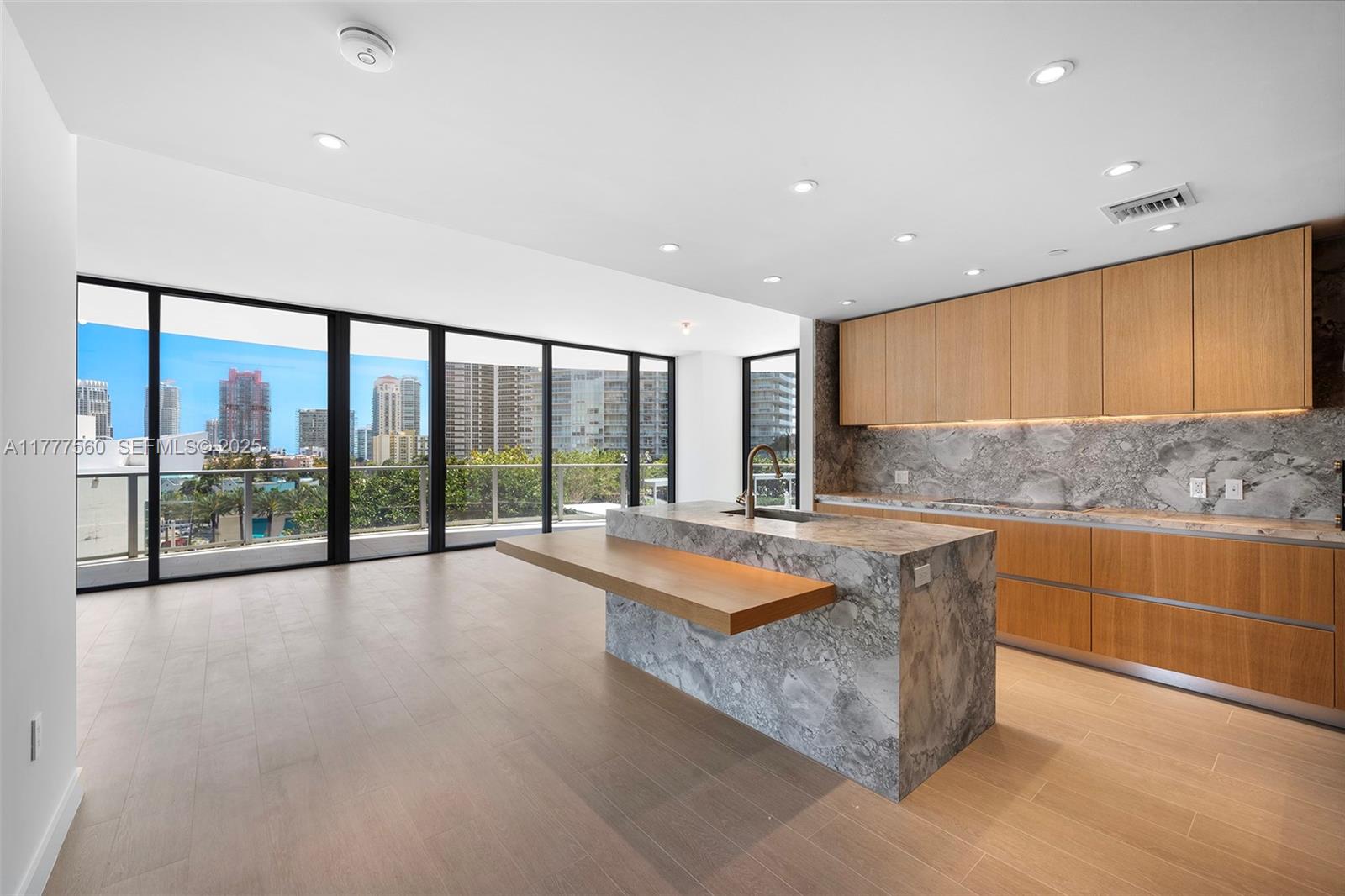 500 Alton Road, Unit 801 Miami Beach, FL 33139 - Photo 4 of 36 a large kitchen with kitchen island a large window in it
