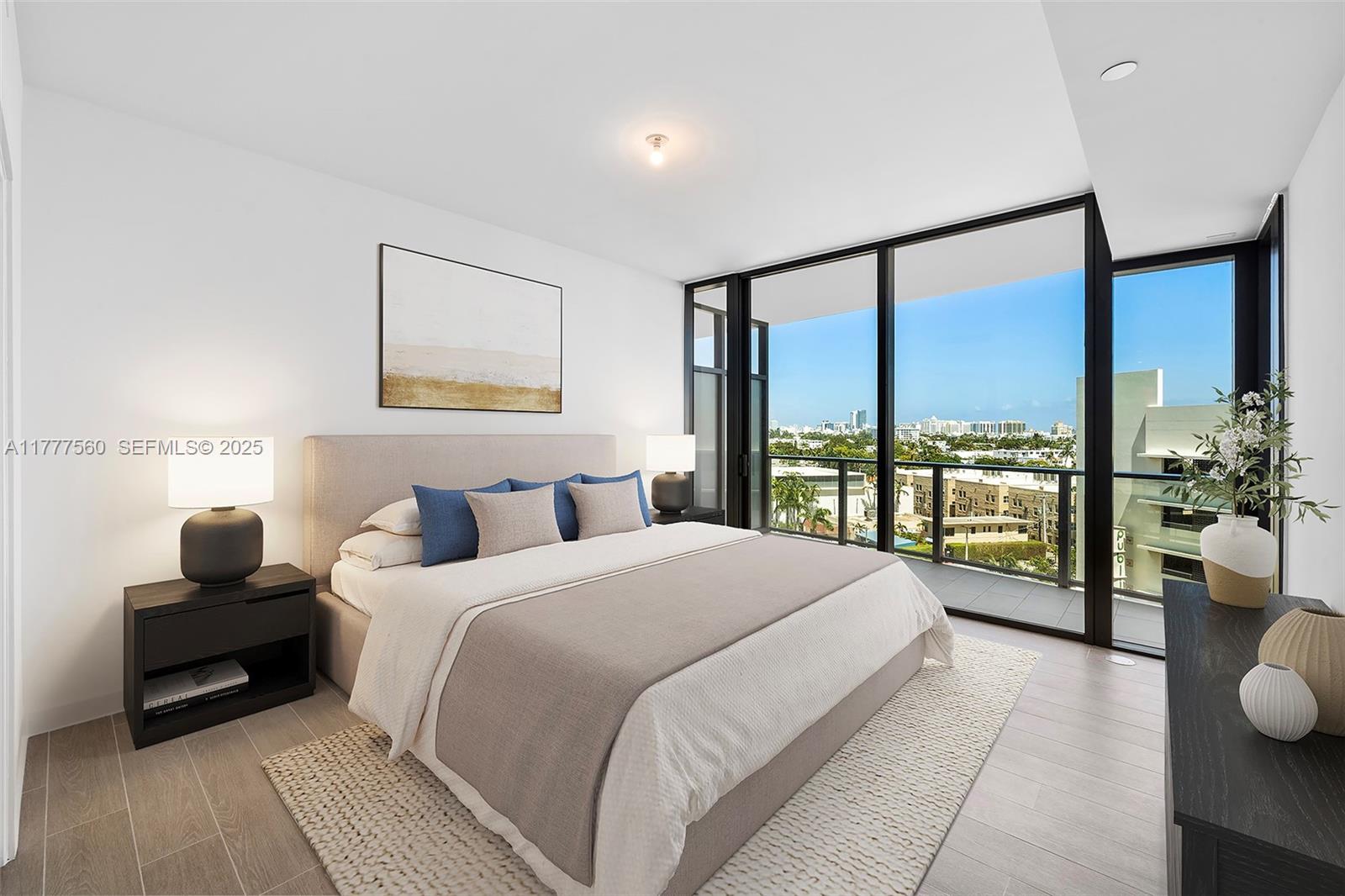 500 Alton Road, Unit 801 Miami Beach, FL 33139 - Photo 10 of 36 a bedroom with a large bed and a large window