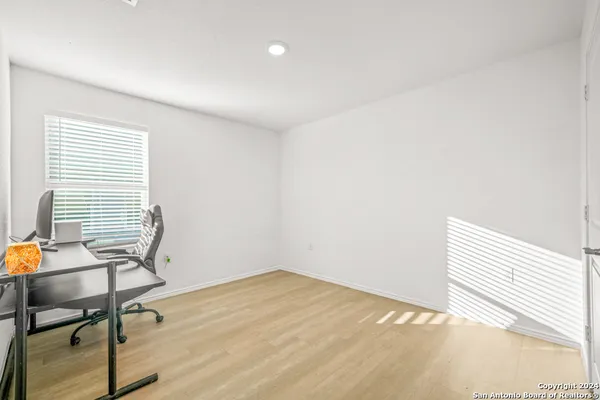 a bathroom with a granite countertop sink a toilet and a mirror
