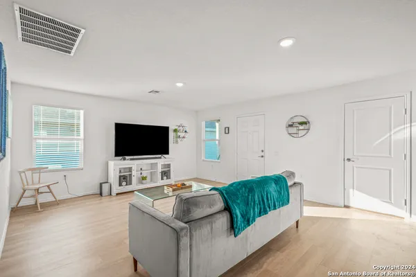 a living room with furniture and kitchen view