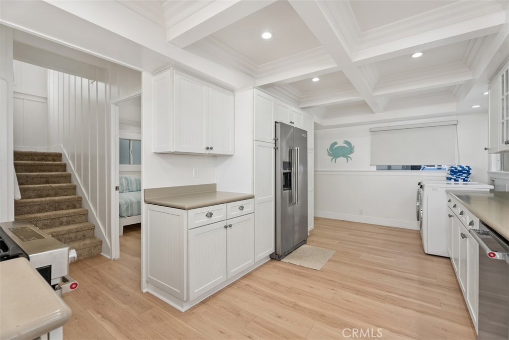 808 West Oceanfront Newport Beach, CA 92661 - Photo 11 of 34 a kitchen with cabinets and a stove