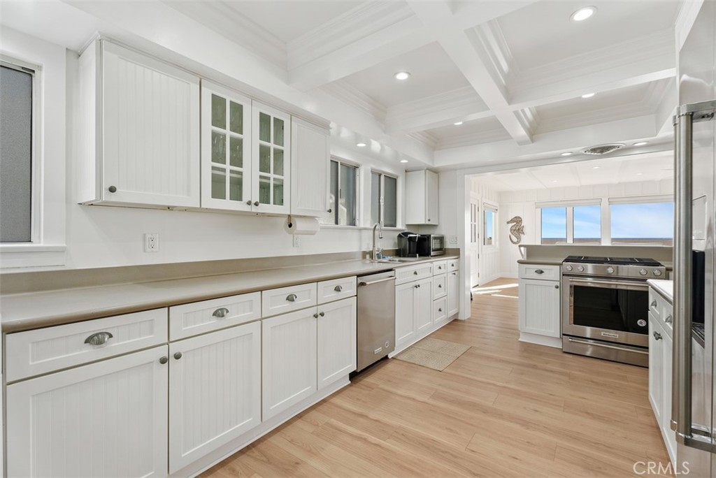 808 West Oceanfront Newport Beach, CA 92661 - Photo 12 of 34 a kitchen with granite countertop white cabinets and white appliances