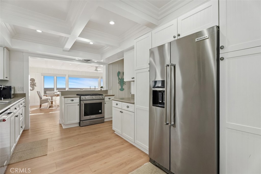 808 West Oceanfront Newport Beach, CA 92661 - Photo 13 of 34 a kitchen with stainless steel appliances a refrigerator sink and stove top oven