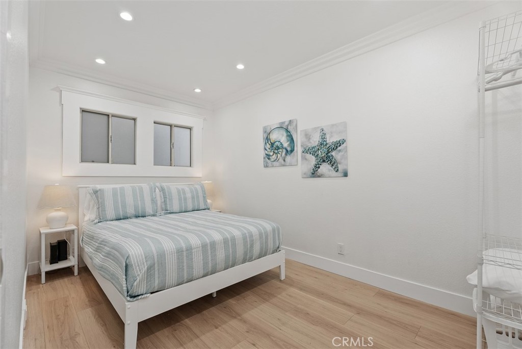 808 West Oceanfront Newport Beach, CA 92661 - Photo 15 of 34 a bedroom with a bed and a painting on the wall