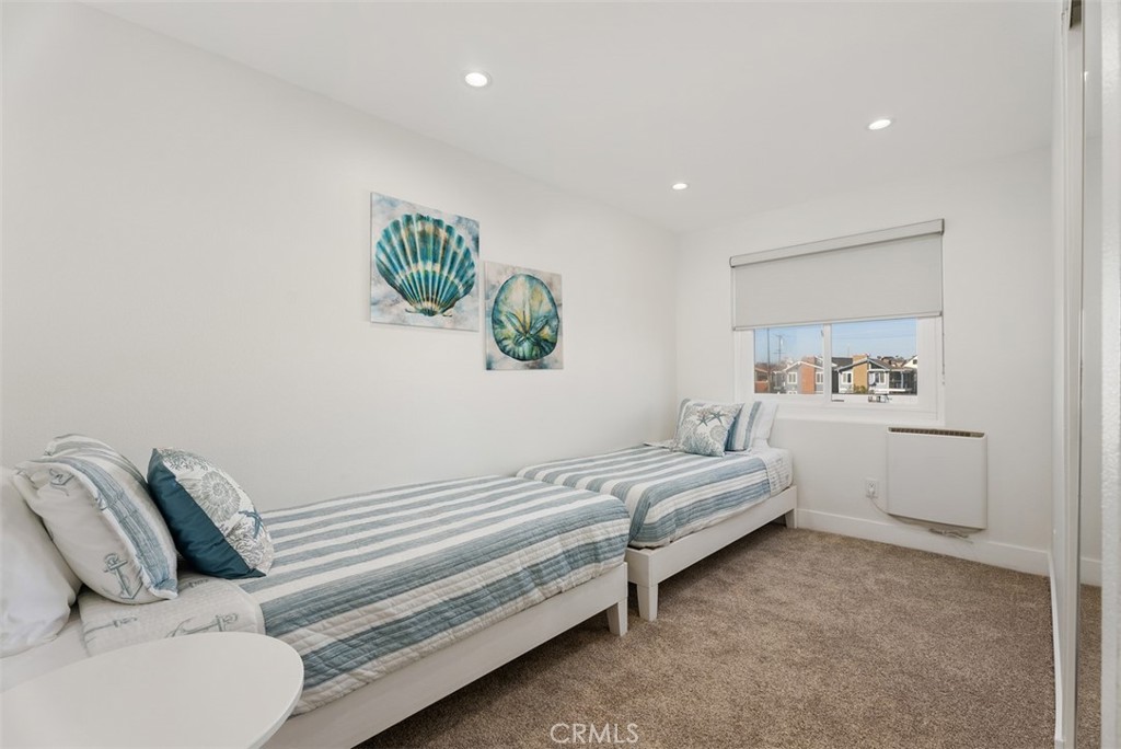 808 West Oceanfront Newport Beach, CA 92661 - Photo 17 of 34 a bedroom with a bed and ceiling fan