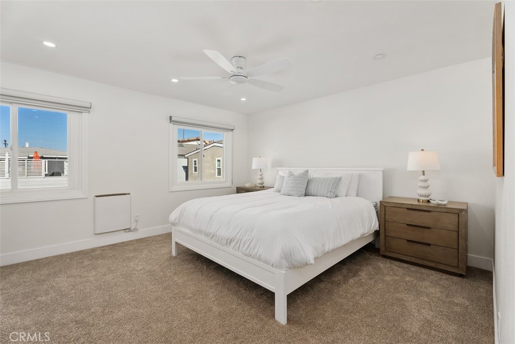 808 West Oceanfront Newport Beach, CA 92661 - Photo 18 of 34 a bedroom with bed and paintings on the wall