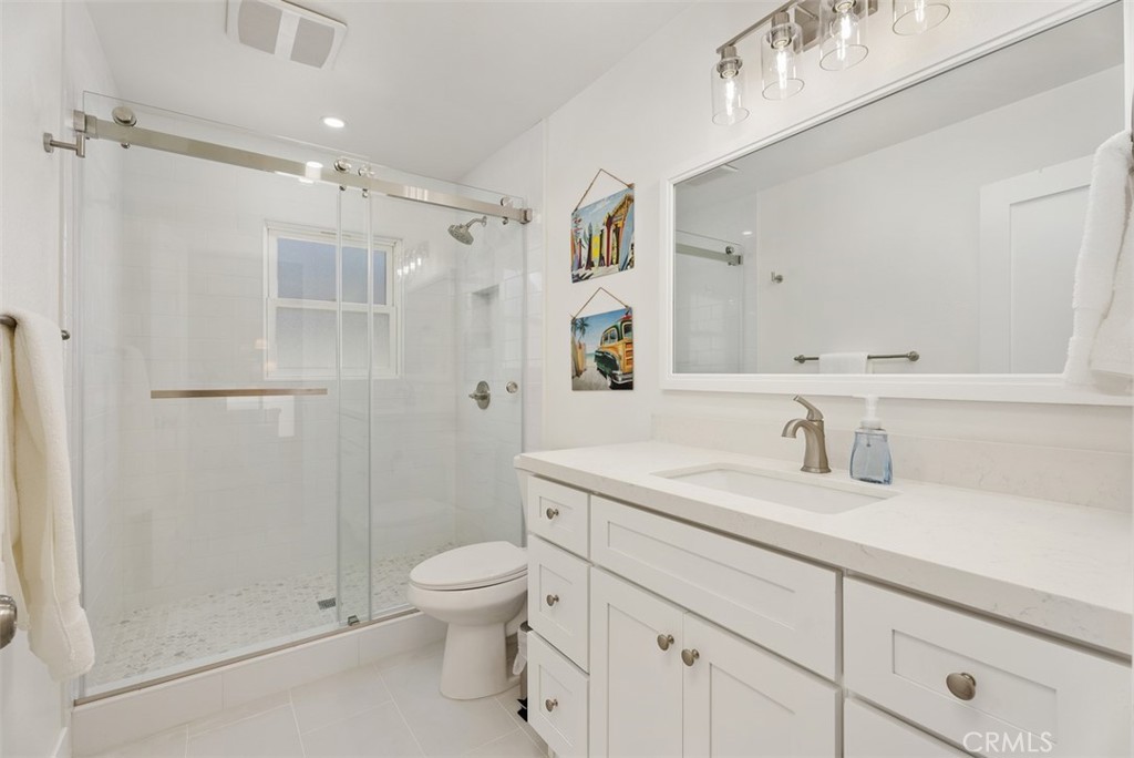 808 West Oceanfront Newport Beach, CA 92661 - Photo 20 of 34 a bathroom with a shower sink vanity mirror and toilet