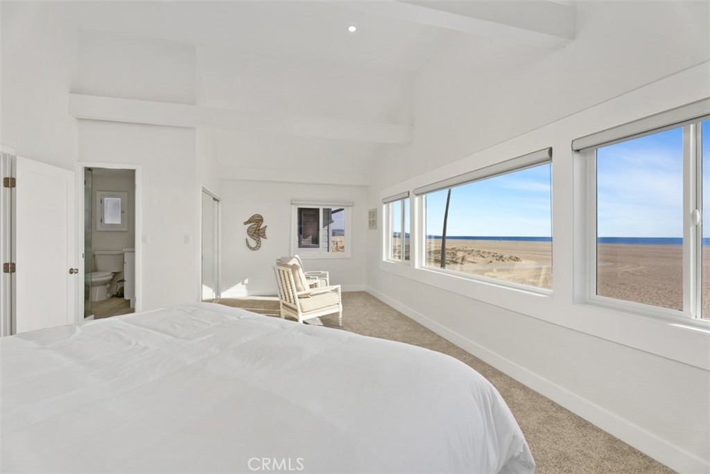 808 West Oceanfront Newport Beach, CA 92661 - Photo 22 of 34 a bedroom with a large bed and a large window
