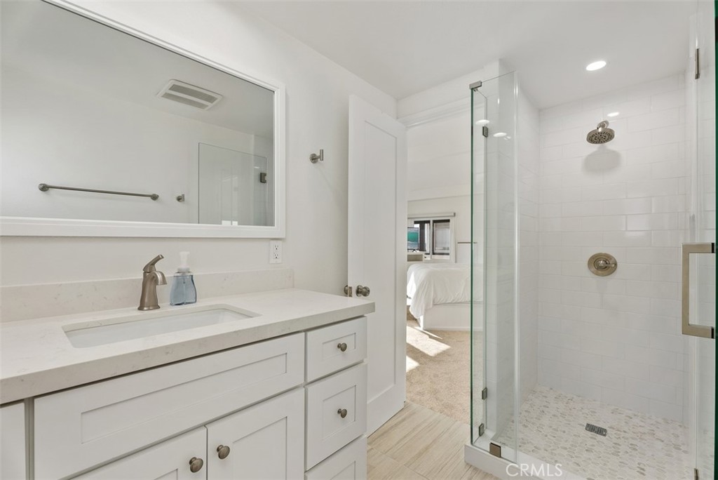 808 West Oceanfront Newport Beach, CA 92661 - Photo 24 of 34 a bathroom with a shower sink vanity and mirror