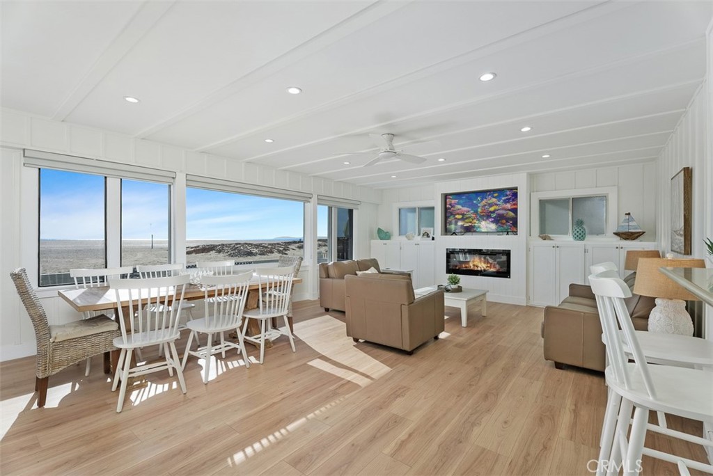 808 West Oceanfront Newport Beach, CA 92661 - Photo 7 of 34 a view of a dining room with furniture window and wooden floor