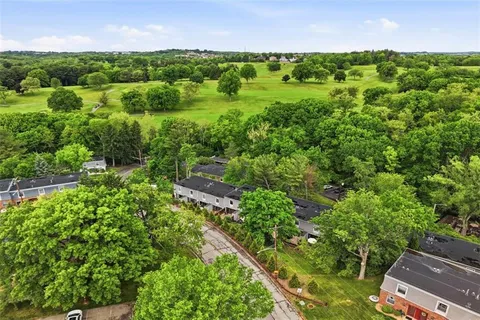 an aerial view of a houses with a yard
