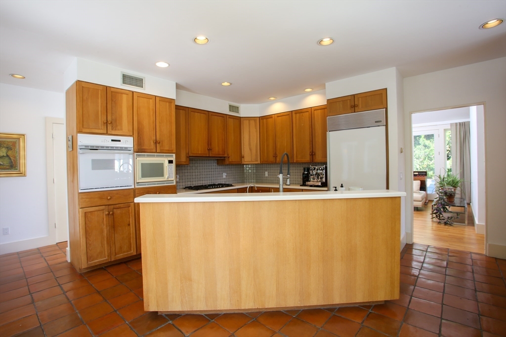 240 Beldingville Road Ashfield, MA 01330 - Photo 18 of 40 a large kitchen with stainless steel appliances a refrigerator a sink dishwasher with a dining table and chairs