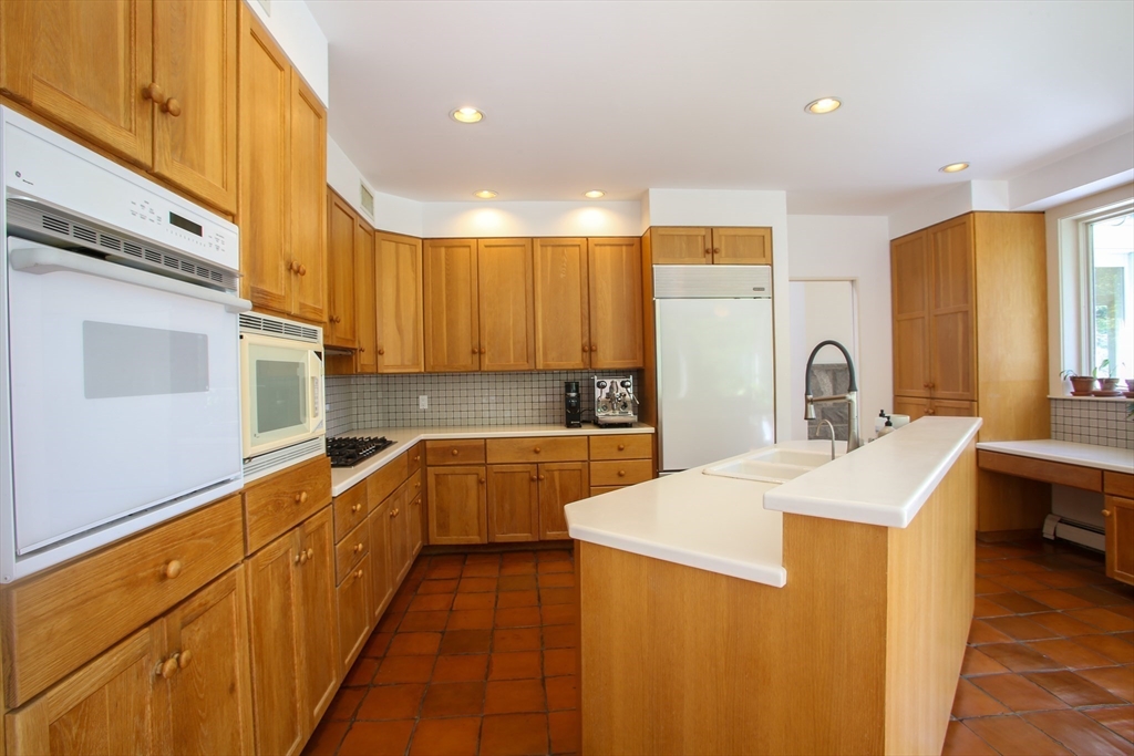 240 Beldingville Road Ashfield, MA 01330 - Photo 19 of 40 a large kitchen with stainless steel appliances a sink dishwasher a stove top oven a refrigerator with wooden cabinets and floor